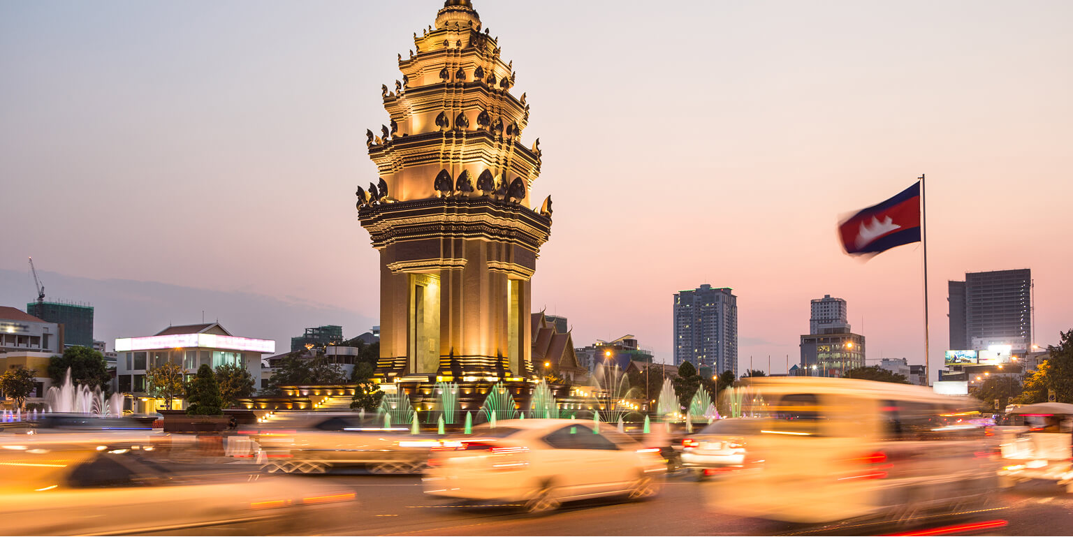 Night time in Cambodia with cars driving around a temple
