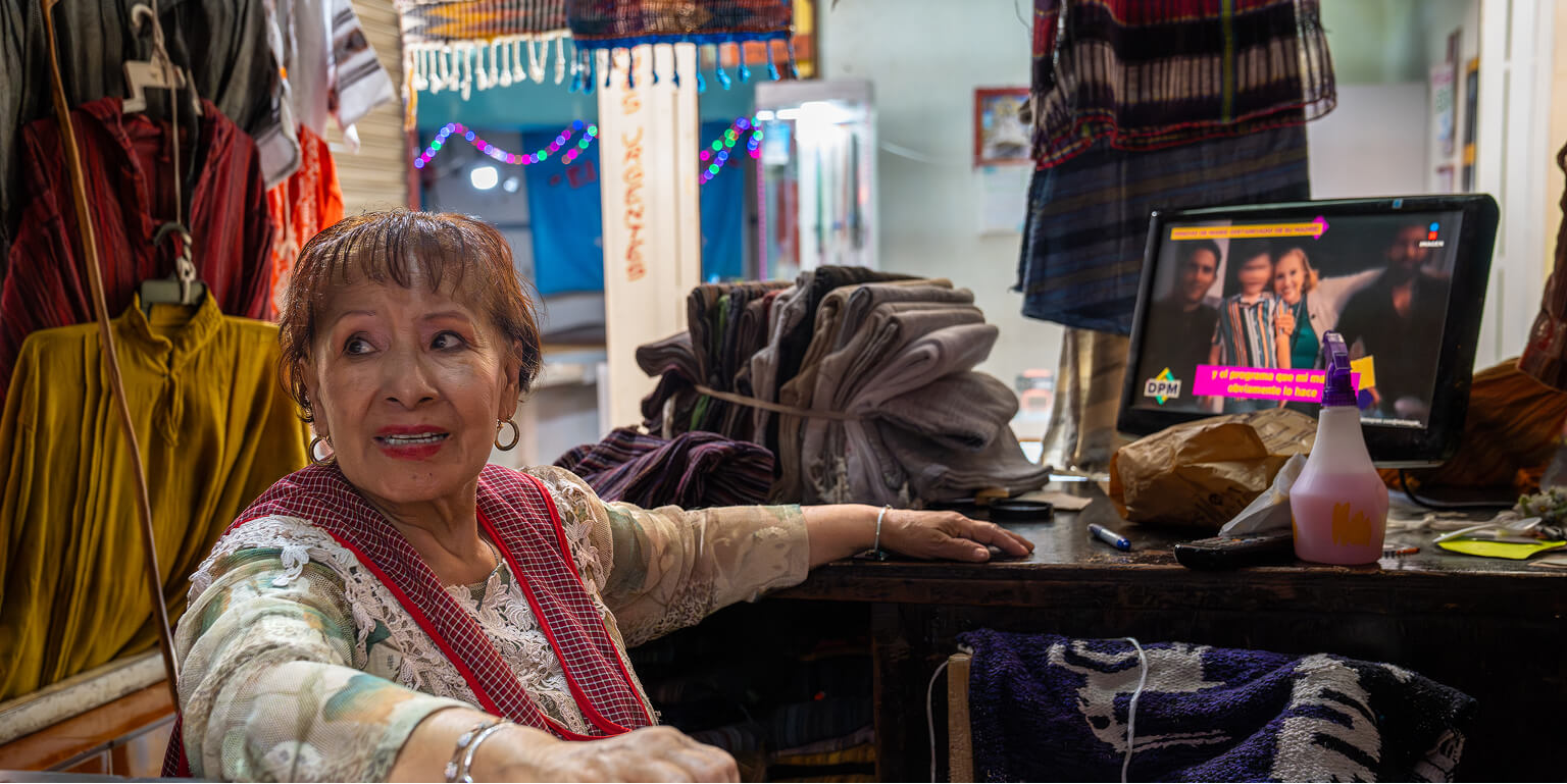 Woman sitting in clothing store in Mexico.
