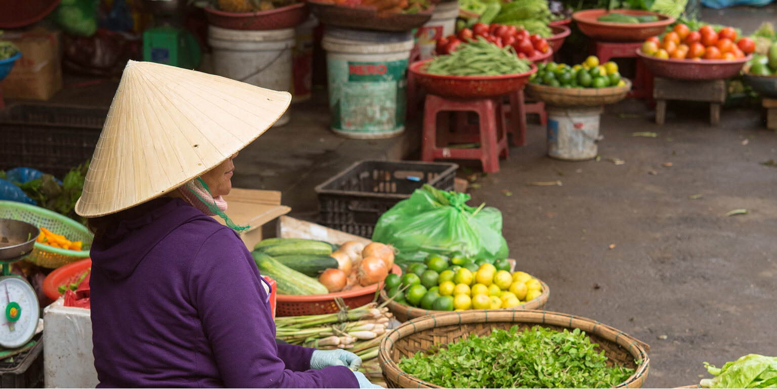 Lady selling fruits and vegetables.